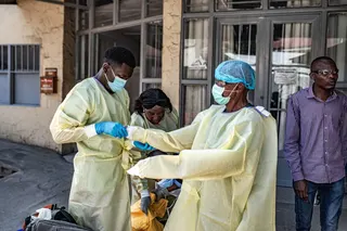 Medical workers put on protective suits in Goma, the Democratic Republic of the Congo, on Thursday. Photo: Xinhua via ZUMA Press/TNS
