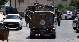 Israeli soldiers take position during a raid in the West Bank city of Nablus on Monday. Photo: EPA