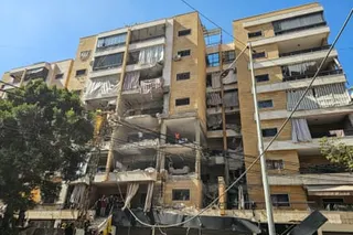 An apartment building with many of its walls and windows ripped out by a missile blast