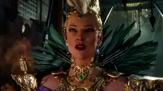 A woman wearing a feathered costume looks confused.