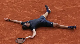 Alexander Zverev lies on the French Open clay after winning the 2026 title
