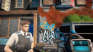 A police officer with curly hair on a sleepy town street