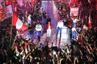 Roberto Sanchez on stage at his closing campaign rally in Lima surrounded by supporters