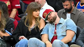 Travis Kelce reacting while Taylor Swift looks on during NBA Eastern Conference Finals game