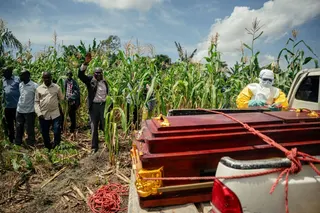 Members of a Congolese Red Cross team place the coffin of a woman suspected of having died from Ebola on a truck ahead of her burial at her home in Bunia. Photo: AFP