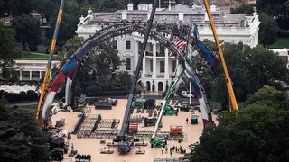 Construction workers preparing the South Lawn of the White House for a UFC match