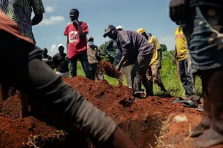 Cemetery workers in the DRC cover the coffin of a woman suspected of having died from Ebola with soil as part of her safe burial at a cemetery in Bunia on Sunday. Photo: AFP