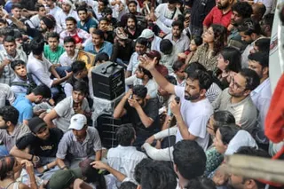 Abhijeet Dipke speaks surrounded by supporters