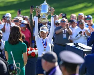 Nelly Korda holds the US Open trophy after her win on Sunday