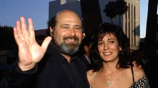 Rob Reiner and Michele Singer standing together at a movie premiere.