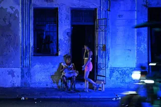 A woman checks a mobile phone during a blackout in Havana’s Centro Habana neighbourhood, Cuba, on June 2. Photo: AFP/Getty Images/TNS