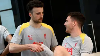 Diogo Jota and Andrew Robertson shake hands