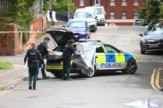 Police officers secure the area around the scene of a stabbing in Belfast, Northern Ireland, on Tuesday. Photo: AP