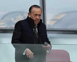 David Sullivan in the stands at the London stadium. He is in his mid-70s, short and stocky with slicked-back dark hair. He wears a black coat and white shirt with a patterned brown tie.