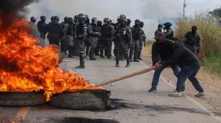 People try to put out a fire set up by demonstrators blocking a highway in a protest against Bolivia's President Rodrigo Paz in San Julian, Bolivia, June 6, 2026. REUTERS/Ipa Ibanez