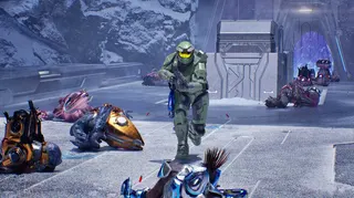 Master Chief runs down a bridge in Halo Campaign Evolved