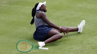 Victoria Mboko of Canada slips on court against Karolina Pliskova of Czechia