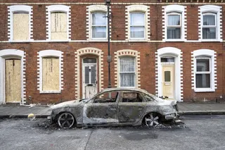 A burnt-out car on a street following riots in Belfast, Northern Ireland, on Wednesday. Photo: EPA