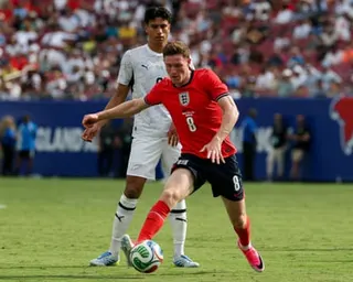 Elliot Anderson of England controls the ball in front of Marko Stamenic of New Zealand during a pre-2026 World Cup friendly in Tampa, Florida.