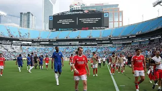 Chelsea and Benfica players walking off the pitch after severe weather in the United States