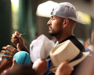Nick Kyrgios of Australia signs balls for fans