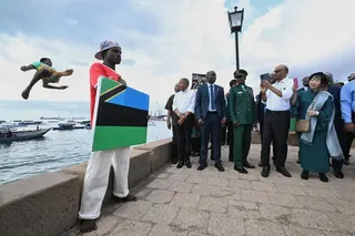 President Tharman Shanmugaratnam and his spouse Jane Ittogi Shanmugaratnam filming a group of locals who welcomed them by diving into the sea in Stone Town in Zanzibar, Tanzania, on June 10.