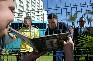 Iran forward Mehdi Taremi signs autographs for a fan outside the Marriott Hotel on Wednesday before leaving for a training session in Tijuana, Mexico.