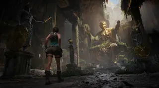 Lara Croft stands in front of a statue in Tomb Raider: Legacy of Atlantis.