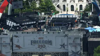 Temporary stands are assembled around a UFC octagon on the South Lawn of the White House