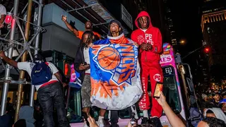 New York Knicks fans climb on an ice cream truck
