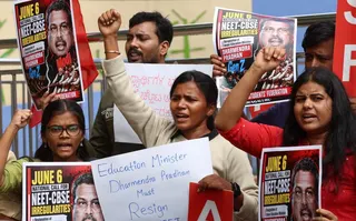 Members of the All India Students Federation hold placards and shout slogans during a protest against the alleged National Eligibility cum Entrance Test paper leak in Bangalore on Sunday. Photo: EPA