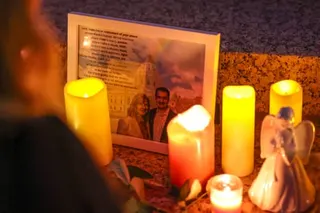 A framed photo of a couple next to candles.