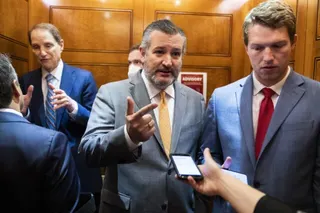 US Senators Ted Cruz and Ron Wyden speaking to people in the US Capitol.