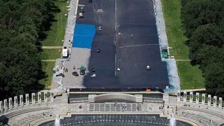 Workers applying blue protective coating to Lincoln Memorial Reflecting Pool in Washington