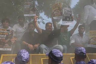 Indian Youth Congress activists climb police barricades as they protest against the exam scandals outside the National Testing Agency office in New Delhi on May 13. Photo: EPA