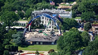 A general view of a domed structure being assembled in front of the White House