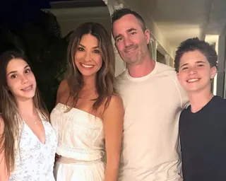 Police officer Marc Pinizzotto and family pose indoors, all smiling at the camera
