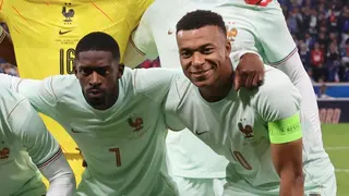 Ousmane Dembele and Kylian Mbappe pose in a pre-match team photo