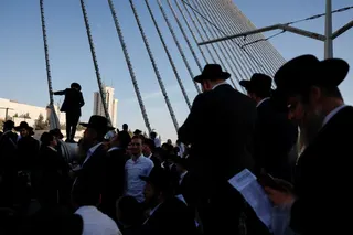 Ultra-Orthodox Jewish men gather on the Ultra-Orthodox Jewish men gather on the Chords Bridge during the "Million Man" protest against Israeli military conscription in Jerusalem [Ammar Awad/Reuters]