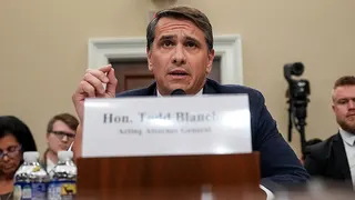 Acting U.S. Attorney General Todd Blanche seated and speaking into a microphone during a congressional hearing in Washington, D.C.