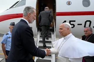 Spain’s King Felipe shakes hands with Pope Leo in front of the Falcon 900B offered by the monarch on Friday. Photo: Vatican Media via Reuters