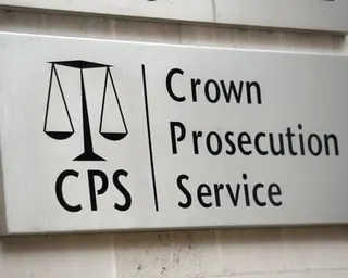 Signage reading 'Crown Prosecution Service' mounted on a wall