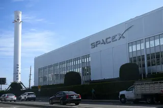 Vehicles drive past a SpaceX Falcon 9 rocket displayed outside a Space Exploration Technologies Corp. facility in Hawthorne, California, on June 8.