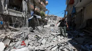 A man walks on rubble at the site an Israeli strike in Tyre, Lebanon, June 12, 2026. REUTERS/Aziz Taher
