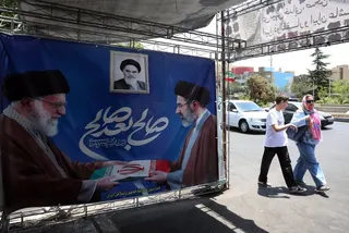 Iranians walk past a poster featuring late Iranian supreme leader Ayatollah Ali Khamenei (left) alongside his son and successor, Supreme Leader Ayatollah Mojtaba Khamenei in Tehran on Thursday. Photo: EPA