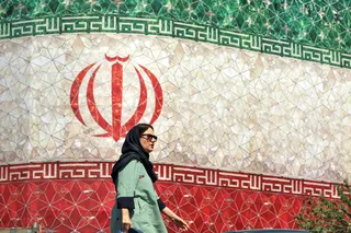 An woman walks past a billboard displaying Iran’s national flag at Enghelab Square in Tehran June 14, 2026. A senior Iranian official told Reuters a final draft ‌of the memorandum of understanding with the US covered a range of issues, from Tehran’s nuclear work to reopening the Strait of Hormuz and US waivers ‌on oil sanctions, with a final deal to be discussed in the 60 days following agreement by the two sides. — AFP pic