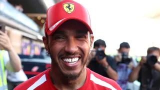 Lewis Hamilton smiles while celebrating his victory for Ferrari in the Barcelona-Catalunya Grand Prix