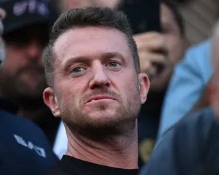 Tommy Robinson stands in a crowd during a protest in Southampton