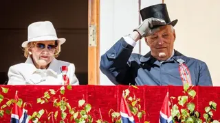 Per Ole Hagen/Getty Images A man and woman on a platform in front of Norwegian flags