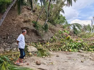 A man stands on a blocked road after a major landslide triggered by an earthquake, in Sarangani Province, the Philippines, on Thursday. Photo: Xinhua